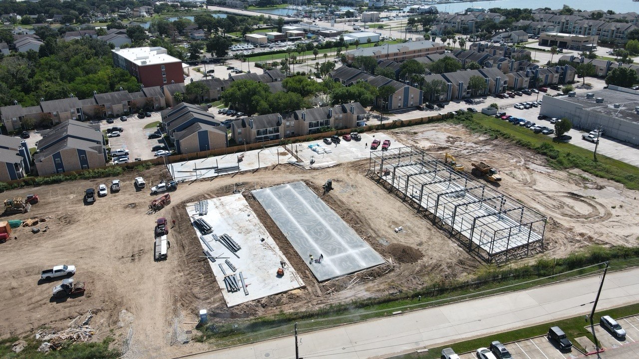 Drone aerial of a ground-up commercial development with steel buildings going up